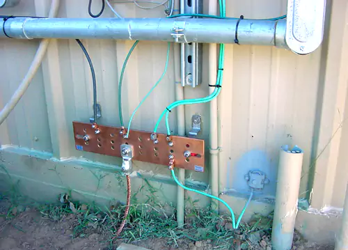 Copper earthing busbar and bonding conductors on a site installation